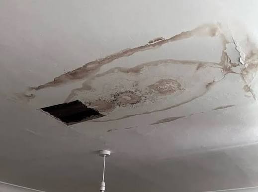 Brown water stain ring on ceiling caused by hidden second-floor bathroom pipe leak in Broomfield