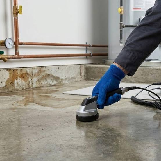 Master technician using electro-acoustic ground sensor for non-invasive slab leak detection in Broomfield CO