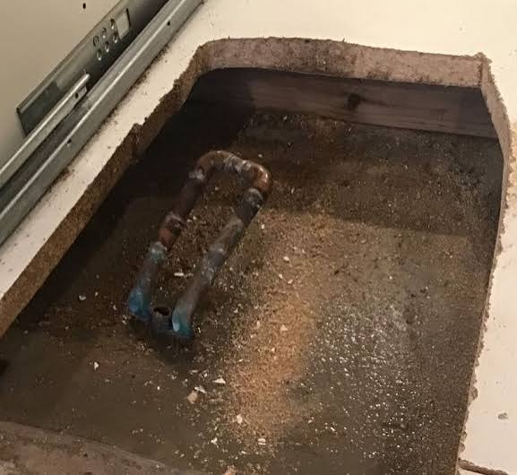 Corroded copper water supply pipe with pinhole leak beneath concrete slab foundation in Broomfield