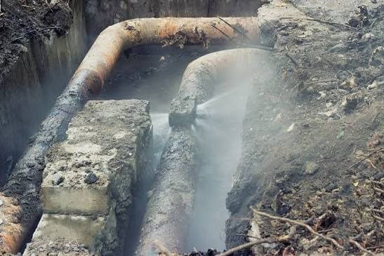 Underground main water supply line leak located in yard trench for non-destructive repair