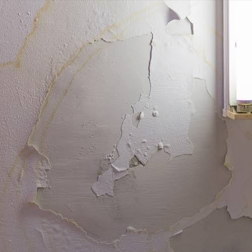 Bubbling and peeling drywall paint from pressurized vertical pipe leak inside wall cavity